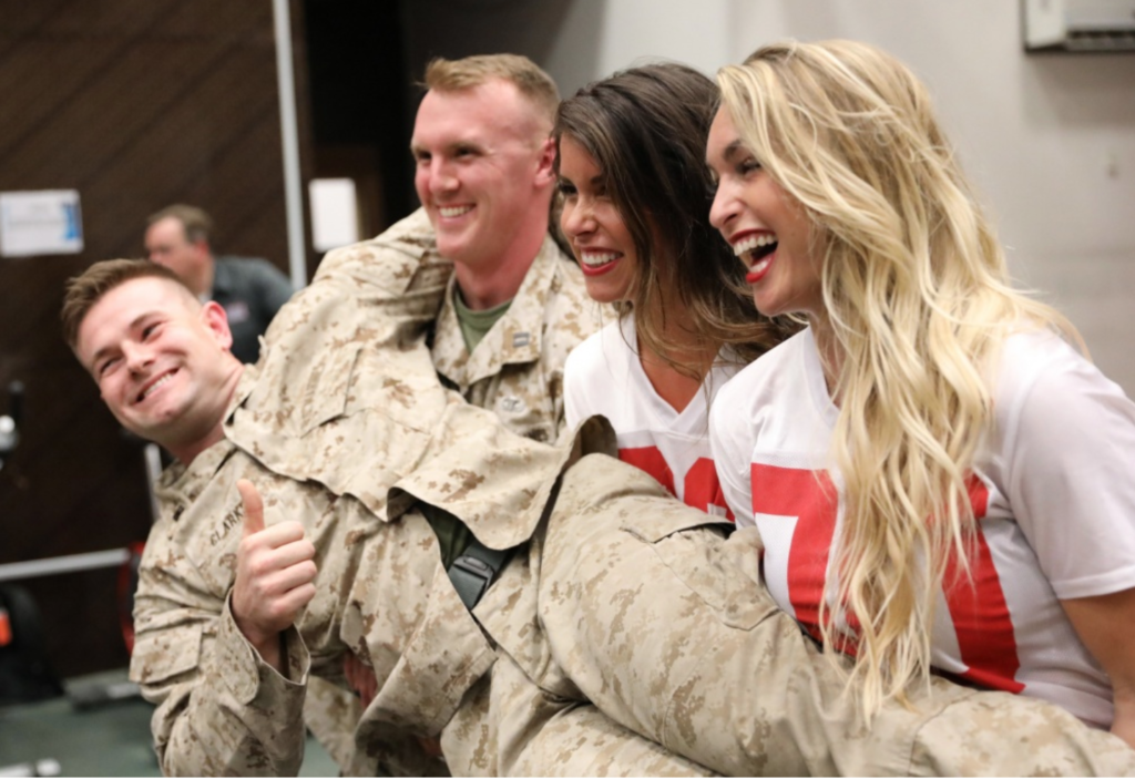 Atlanta Falcons cheerleaders talk to U.S. and coalition service members, during a meet and greet in the gym on Union III in Baghdad, Iraq, June 17, 2018. Members of the Atlanta Falcons conducted a tour hosted by the USO to U.S. military camps throughout Iraq. (U.S. Army photo by Master Sgt. Horace Murray)