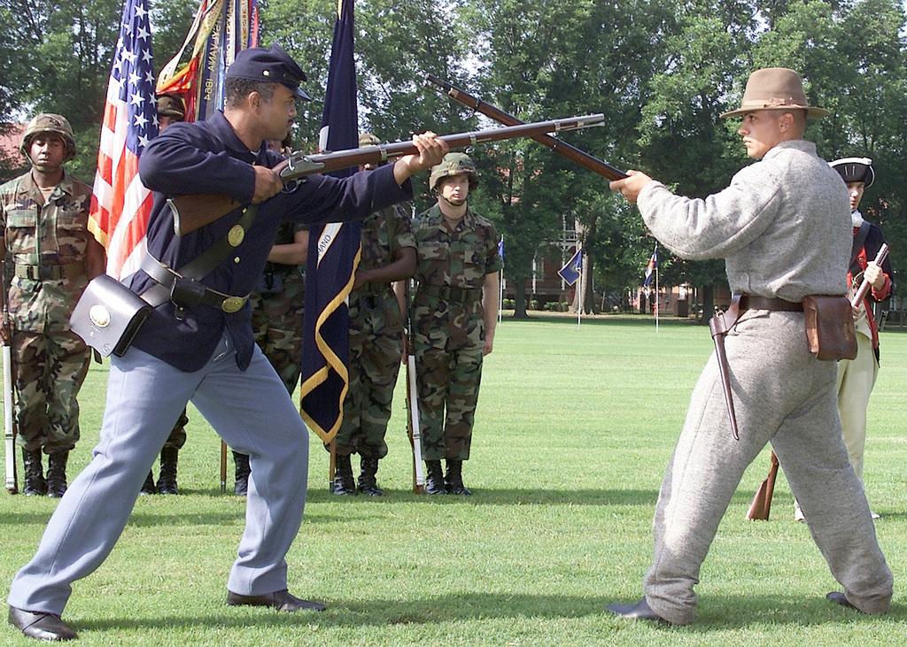 Dressed in the uniform of the Union Army and the Confederate Army, two Re-enactors, armed with musket rifles, perform a re-enactment of a standoff during the Civil War. A Living History Pageant was the center of the Army's 226th Birthday Celebration at Fort McPherson, GA.