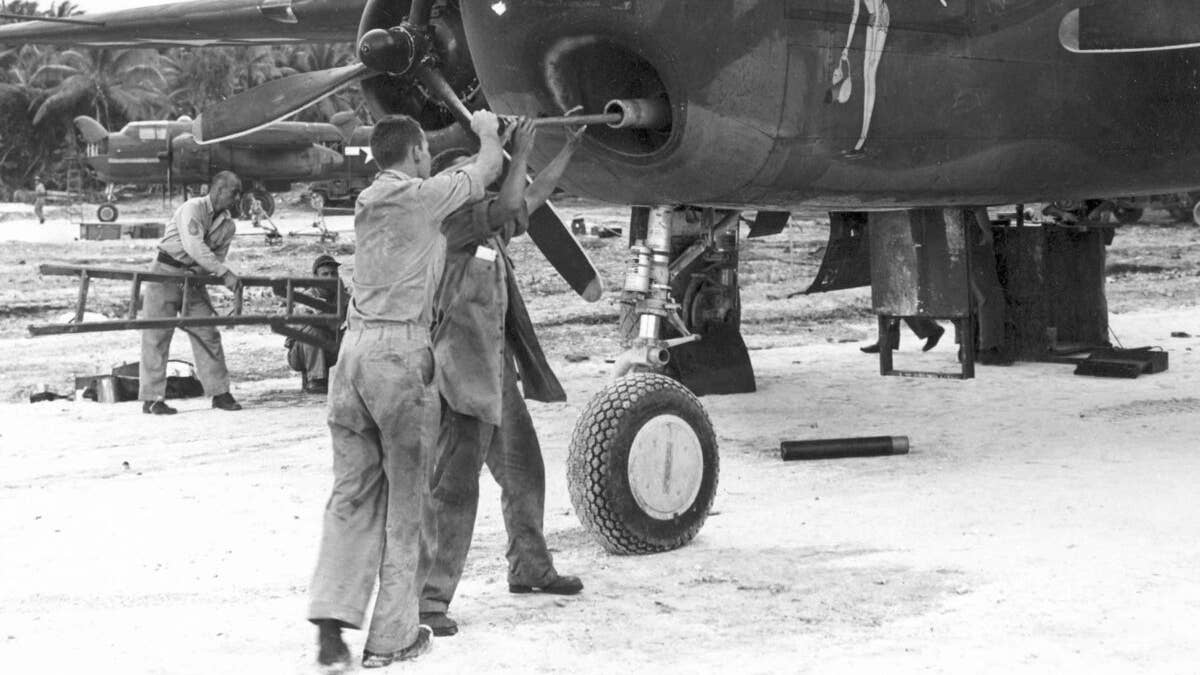 North American B-25G "Pride of the Yankees" in the Gilbert Islands. Note the spent 75mm shell casings used as covers for the .50-cal. machine guns. (U.S. Air Force photo)