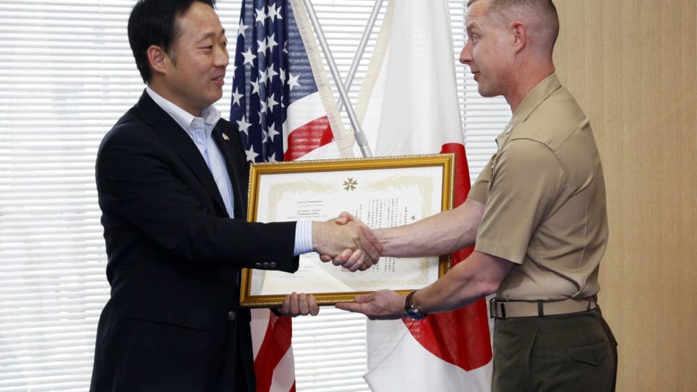 Yoshihiko Fukuda, Iwakuni city mayor, presents Col. James C. Stewart, station commanding officer, with a letter of appreciation at the Iwakuni cityhall, June 13, for the station’s contribution during Operation Tomodachi. Operation Tomodachi was the joint relief effort conducted by the U.S. and Japanese government to help the victims of the 9.0 magnitude earthquake and tsunami that shook northern Japan March 11.