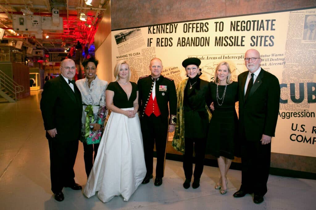 Lisi (left) with CMC General Robert Neller (center), Gerry Byrne(far right) and beautiful ladies aboard USS Intrepid in NYC for Birthday Gala (2018). Photo courtesy of Joe Lisi.