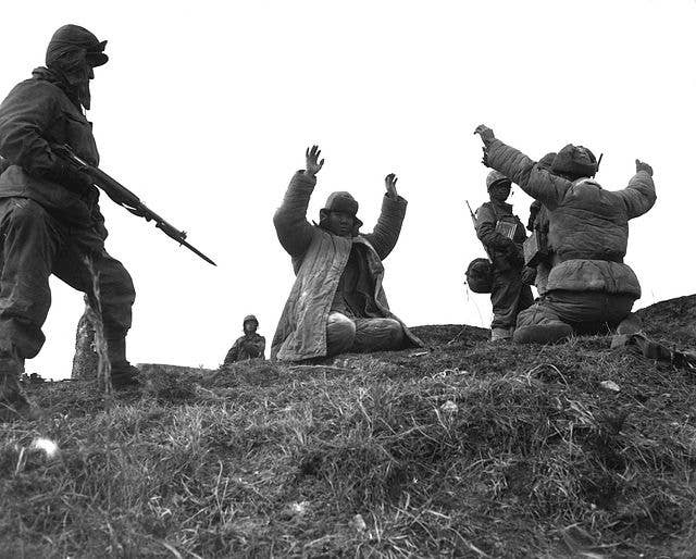 Men of the 1st Marine Division capture Chinese Communists during fighting on the central Korean front. Hoengsong, March 2, 1951. Pfc. C. T. Wehner. (Marine Corps) NARA FILE #: 127-N-A6759<br>Pfc. C. T. Wehner. (Marine Corps)