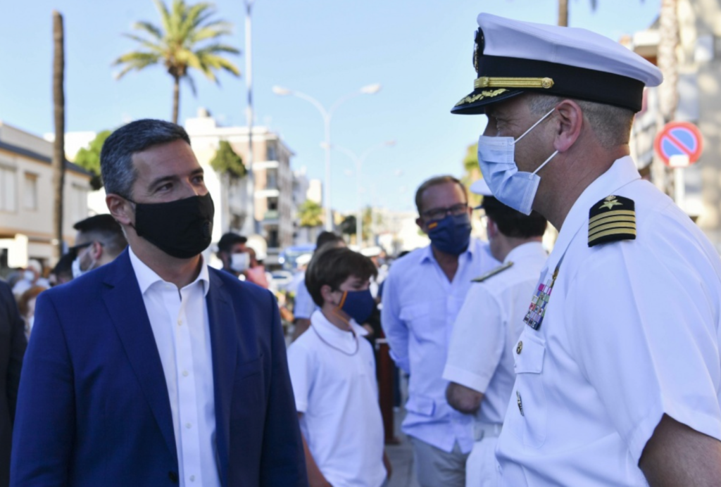 Javier Ruiz Arana, mayor of Rota, left, speaks with Capt. David Baird, commanding officer of Naval Station Rota, Spain, during a flag raising ceremony held by the city of Rota in honor of citizen efforts in the fight against the Covid-19 pandemic. During the ceremony, a new monument was revealed honoring the victims, those who recovered, and the citizens who contributed in the fight against the disease. (U.S. Navy photo by Mass Communication Specialist 2nd Class Eduardo Otero)