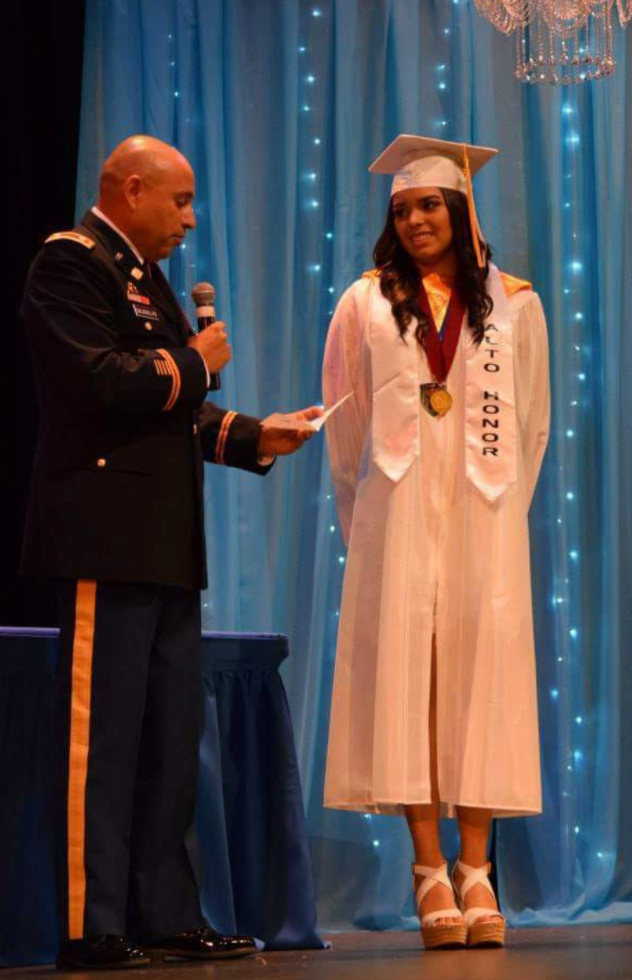 Assistant Chief of Staff Lt. Col. Arturo Calzadillas Jr. (left) presents a Certificate of Appreciation to Jomarly Cruz Galarza, 17, (right), daughter of Sgt. 1st Class Joel Cruz, assigned to the 1st Mission Support Command, U.S. Army Reserve-Puerto Rico, during her high school graduation ceremony held at Centro de Bellas Artes of Guaynabo, May 22.