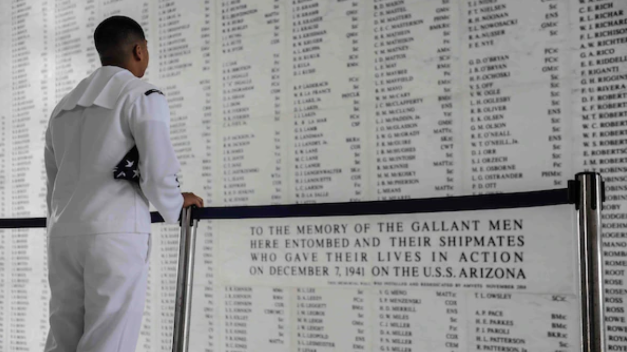 Yeoman 2nd Class Christopher Buco, assigned to the "Golden Eagles" of Patrol Squadron (VP) 9, reads the list of fallen military members following colors onboard the USS Arizona Memorial in Pearl Harbor, Hawaii. The memorial marks the resting place of more than 1,000 Sailors and Marines who were killed aboard USS Arizona (BB 39) during the 1941 attack on Pearl Harbor. (U.S. Navy photo by Mass Communication Specialist 3rd Class Amber L. Porter/Released)