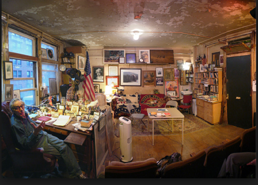 Modica in his office with the Marine Corps flag on the couch and the Vietnam War painting <em>Reflections</em> center of the wall. Photo courtesy of robertmodica.tumblr.com.