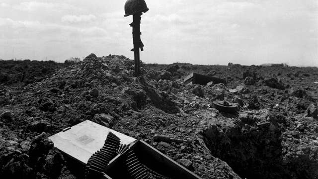 The spirit of the American Soldier: this beachhead is secure. Fellow Soldiers erected this monument to an American Soldier somewhere on the shell-blasted coast of Normandy. Photo courtesy of Center of Military History.