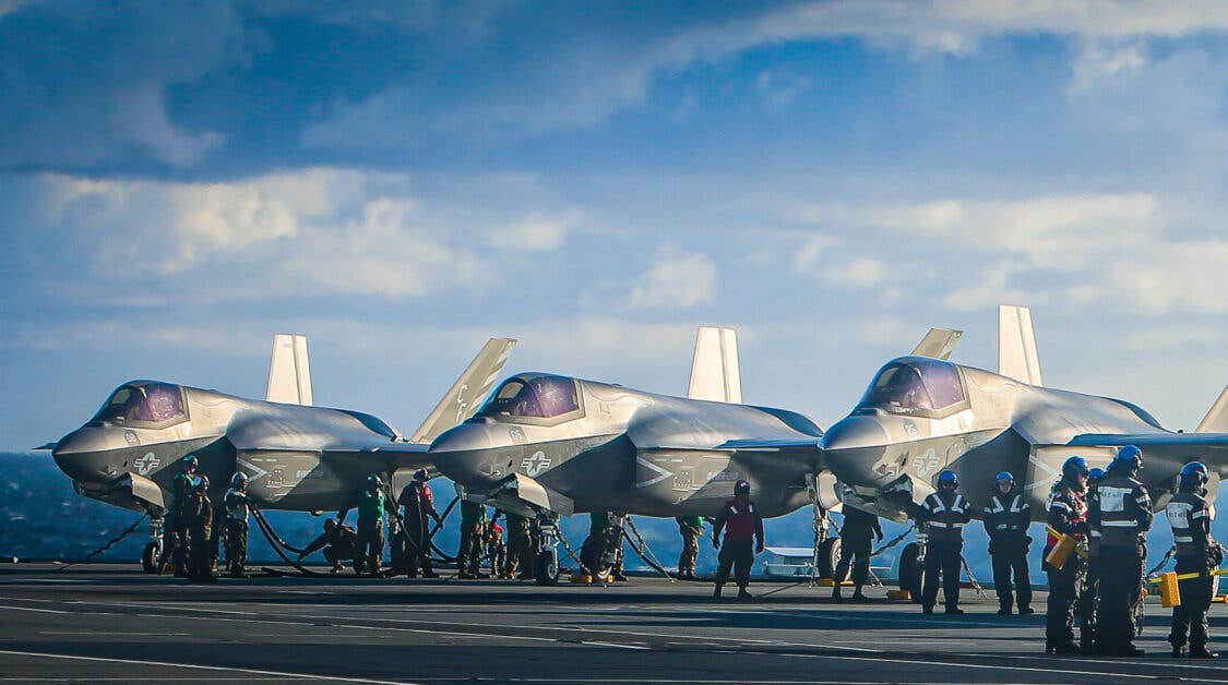 NORTH SEA (Oct. 10, 2020) Marines with Marine Fighter Attack Squadron (VMFA) 211 conduct pre-flight checks on F-35B Lightning II Joint Strike Fighters aboard the Royal Navy aircraft carrier HMS Queen Elizabeth (R 08) in the North Sea, Oct. 10, 2020. VMFA-211 is an F-35B Lightning II squadron assigned to Marine Aircraft Group 13, 3rd Marine Aircraft Wing. Its mission is to intercept and destroy enemy aircraft under all weather conditions and attack and destroy surface targets in support of Fleet Marine Expeditionary Forces. (U.S. Marine Corps photo by 1st Lt. Zachary Bodner)