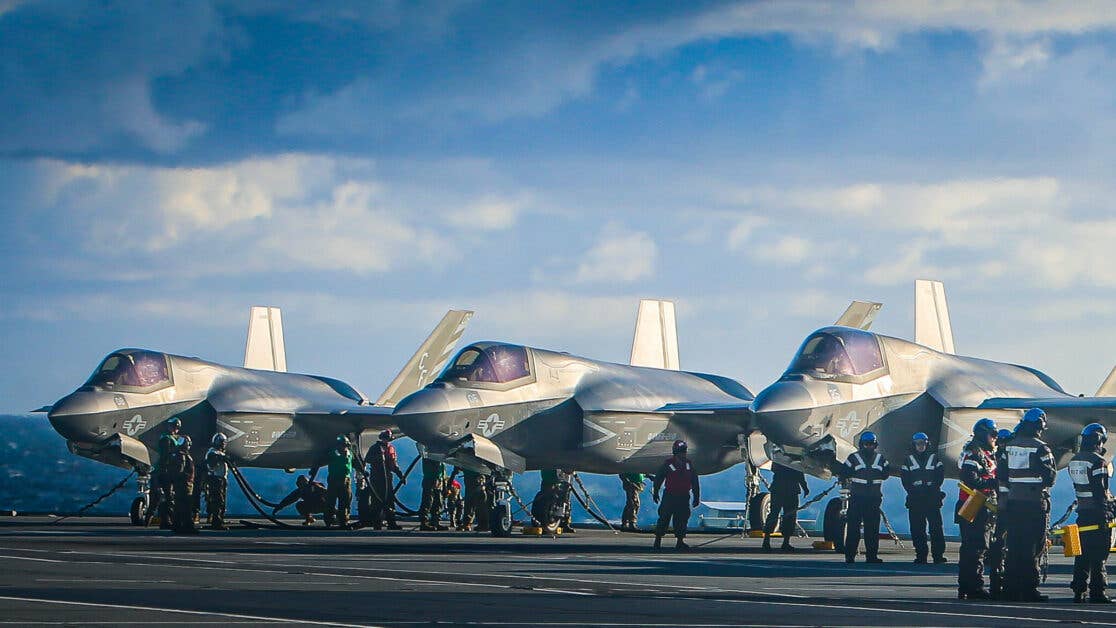 NORTH SEA (Oct. 10, 2020) Marines with Marine Fighter Attack Squadron (VMFA) 211 conduct pre-flight checks on F-35B Lightning II Joint Strike Fighters aboard the Royal Navy aircraft carrier HMS Queen Elizabeth (R 08) in the North Sea, Oct. 10, 2020. VMFA-211 is an F-35B Lightning II squadron assigned to Marine Aircraft Group 13, 3rd Marine Aircraft Wing. Its mission is to intercept and destroy enemy aircraft under all weather conditions and attack and destroy surface targets in support of Fleet Marine Expeditionary Forces. (U.S. Marine Corps photo by 1st Lt. Zachary Bodner)