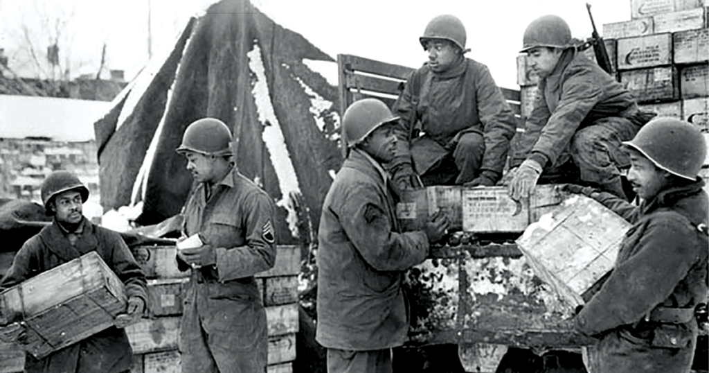 Soldiers from the 4185th Quartermaster Service Company (<em>left to right</em>), Pvt. Harold Hendricks, Staff Sgt. Carl Haines, Sgt. Theodore Cutright, Pvt. Lawrence Buckhalter, Pfc. Horace Deahl, and Pvt. David N. Hatcher, load trucks with rations bound for frontline troops September 1944 in Liege, Belgium. (Photo courtesy of the U.S. Army)