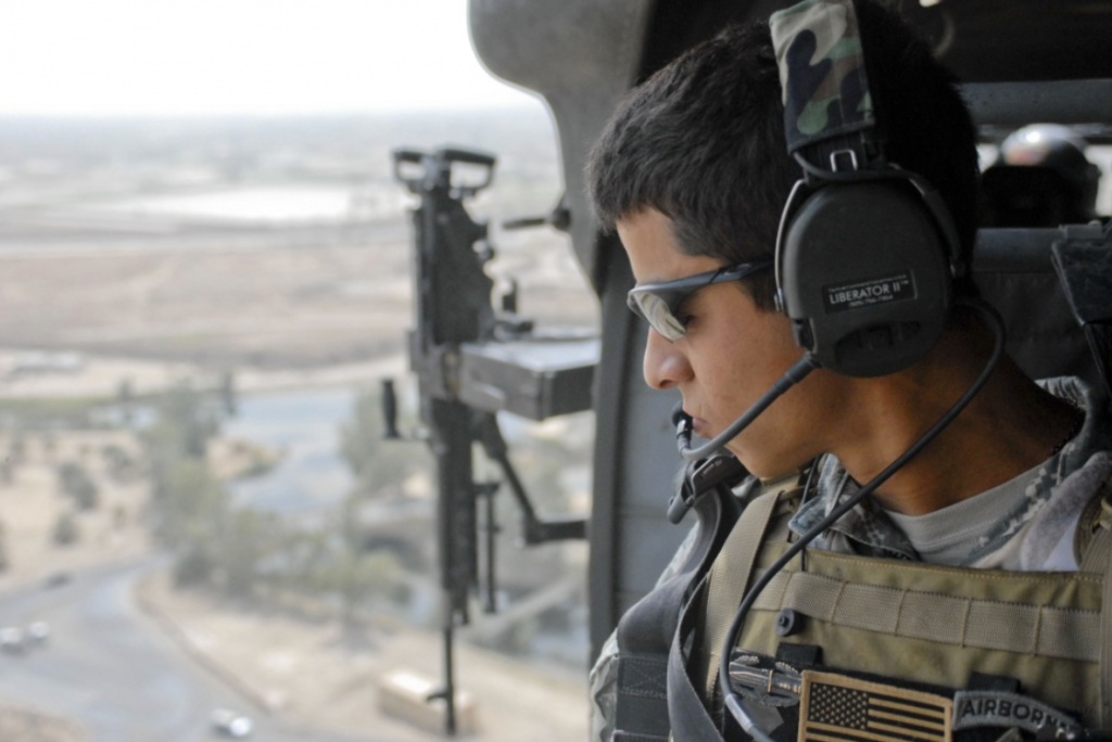 Logan Salah, an interpreter with Multi-National Division - Center, rides a helicopter above Camp Liberty for a mission to meet with Iraqi leaders July 31, 2008.