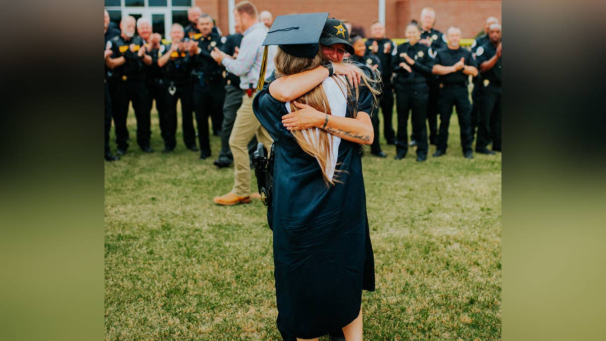 2 Daughters honor slain police and firefighter dads at high school graduation