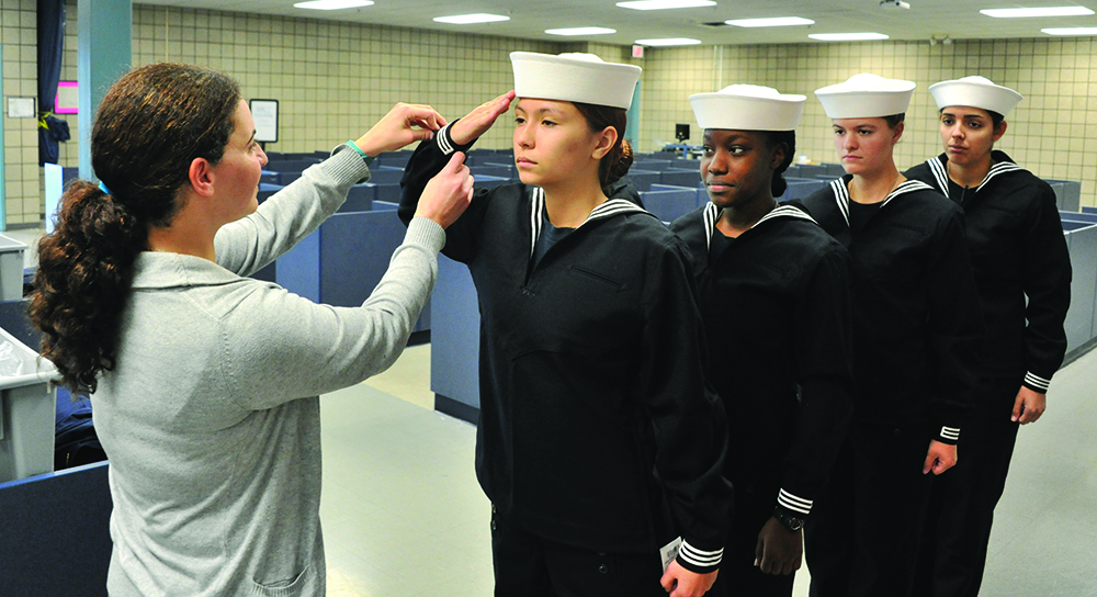 161027-N-SL853-043 GREAT LAKES, Ill. (Oct. 27, 2016) Recruits from Division 904 are fitted by Navy Exchange Uniform Issue employees in their new dress blue jumper top traditionally known as the “Crackerjack,” during second uniform issue Oct. 27, at Recruit Training Command. The recruits were the first females to receive the dress blue jumpers as part of the Navy initiative to have uniformity among Sailors. (U.S. Navy photo by Chief Petty Officer Seth Schaeffer/Released).