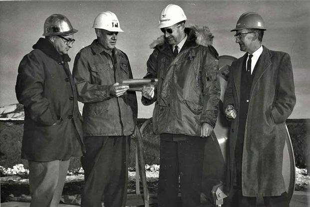 In a ceremony at Malmstrom AFB, Colonel Harry E. Goldsworthy, SATAF commander, accepts a symbol of the first completed Minuteman operational silo from Army Area Engineer Colonel Arthur H. Lahlum, Nov. 13, 1961. (U.S. Air Force)