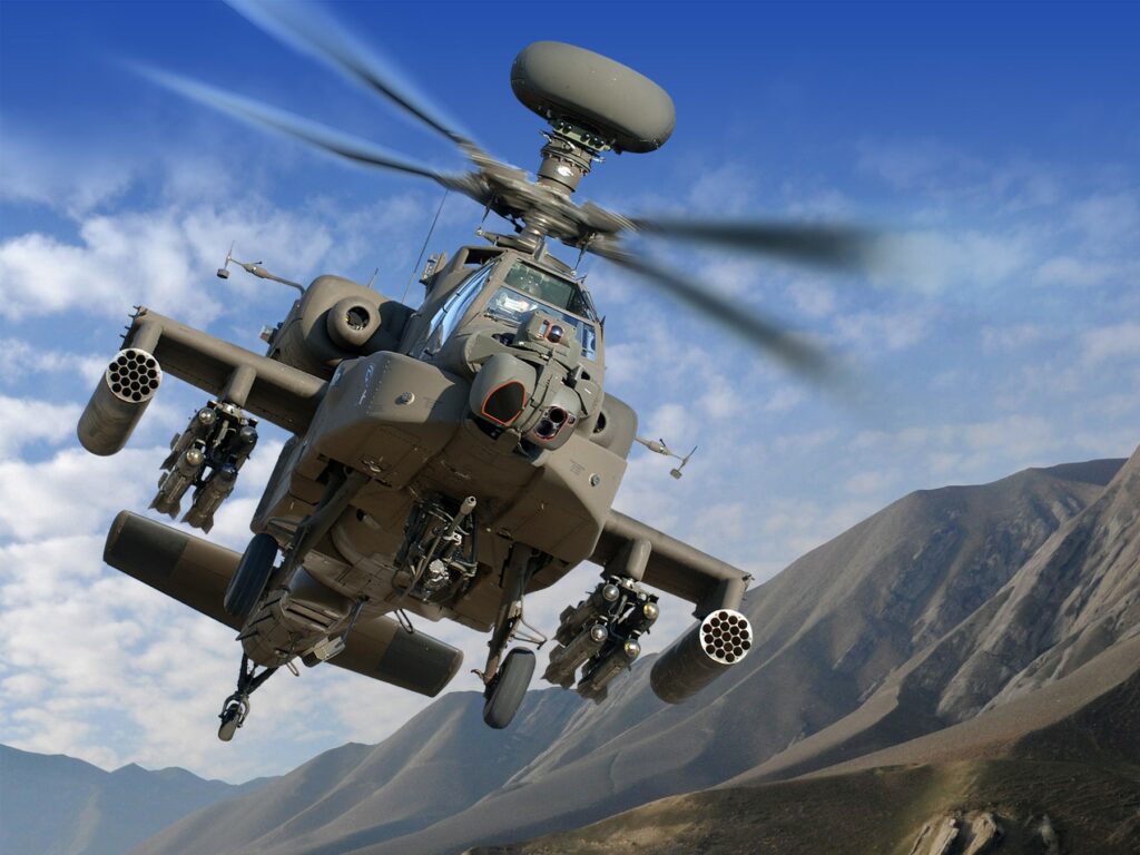 Apache helicopter flying over mountains