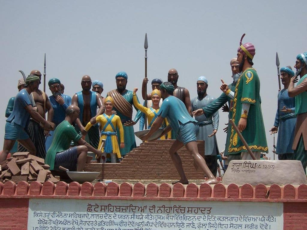 Sculpture depicting Wazir Khan overseeing the execution of the younger sons of Shri Guru Gobind Singh Ji. (Wikimedia Commons)