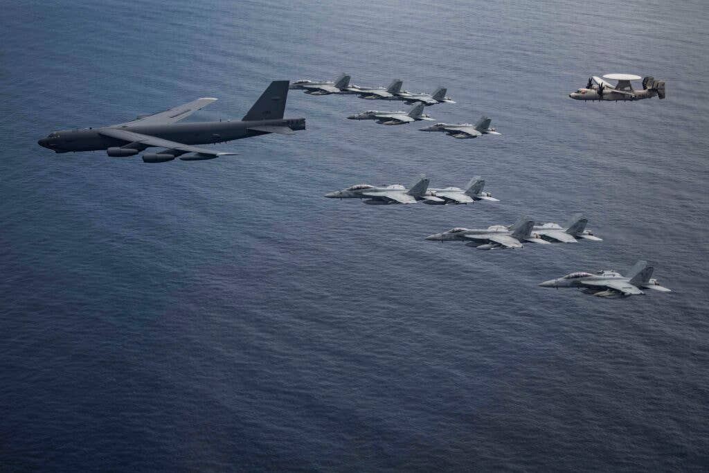 The majestic BUFF takes its grandchildren for an outing over the South China Sea (U.S. Navy photo by Lt. Cmdr. Joseph Stevens)