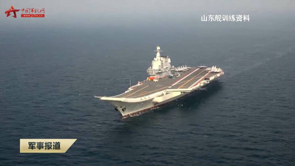 This screen grab taken from a report by Chinese military channel js7tv.cn on May 3, 2021, shows stock image of aircraft carrier Shandong during an exercise in an unspecified location.