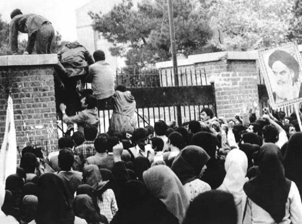 Iranian students climbing the U.S. Embassy gates in Tehran (Wikimedia Commons)