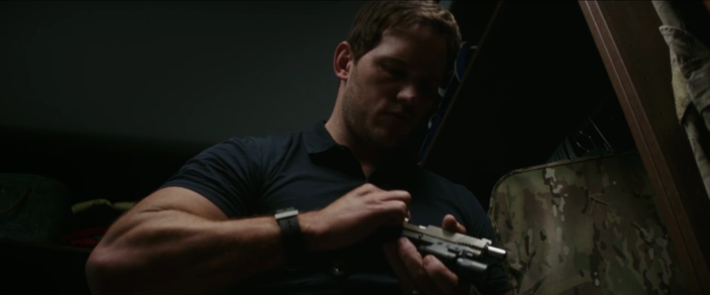 <em>Dan (Chris Pratt) practices good gun safety and checks the chamber of his Kimber Warrior upon retrieving it from his safe (Paramount Pictures<em>/Amazon</em>)</em>