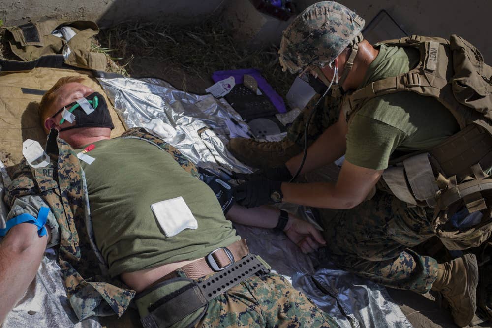 U.S. Marine Corps Cpl. Giovanni E. Lerma, a combat engineer with Task Force Koa Moana 21, I Marine Expeditionary Force, checks the vitals of Lt. Col. Jason R. Reukema, commander of Task Force Koa Moana 21, while participating in the Valkyrie Whole Blood Transfusion Course on Marine Corps Base Camp Pendleton, California, May 6, 2021. This training increased the deployment readiness of the task force by enabling Marines and corpsmen to work together to provide life-saving blood to a casualty on the battlefield.&nbsp;<br>(U.S. Marine Corps photo by&nbsp;<a href="https://www.dvidshub.net/portfolio/1504873/marvin-lopeznavarro" target="_blank" rel="noreferrer noopener">Sgt. Marvin Lopeznavarro</a>/ <a href="https://www.dvidshub.net/unit/I-MEF" target="_blank" rel="noreferrer noopener">I Marine Expeditionary Force</a>)