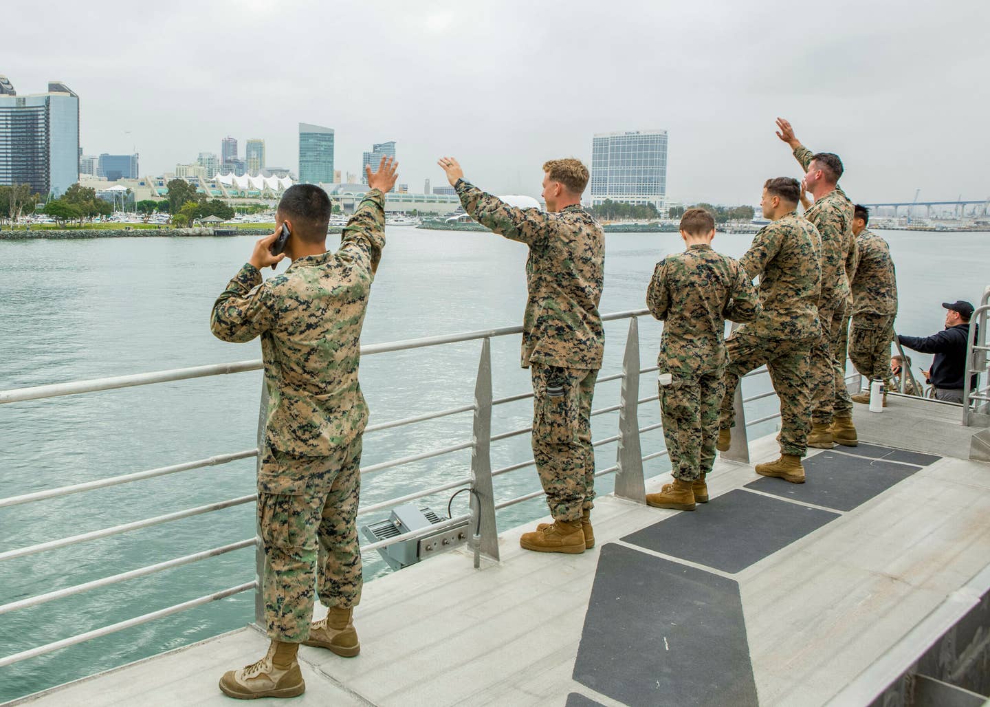U.S. Marines and Sailors with Task Force Koa Moana (TF KM) 20, I Marine Expeditionary Force, wave from a distance to their friends and family as they depart San Diego, July 2020. (U.S. Marine Corps photo by Cpl. Anabel Abreu Rodriguez)