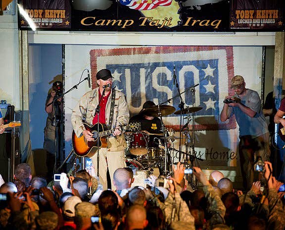 <em>Toby Keith plays to a full audience of nearly 2,000 service men and women at Camp Taji, Iraq, April 26, 2011. USO Photo by Dave Gatley</em>