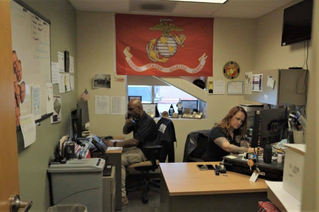 Teague and Anderson taking calls at the VMET's command center.