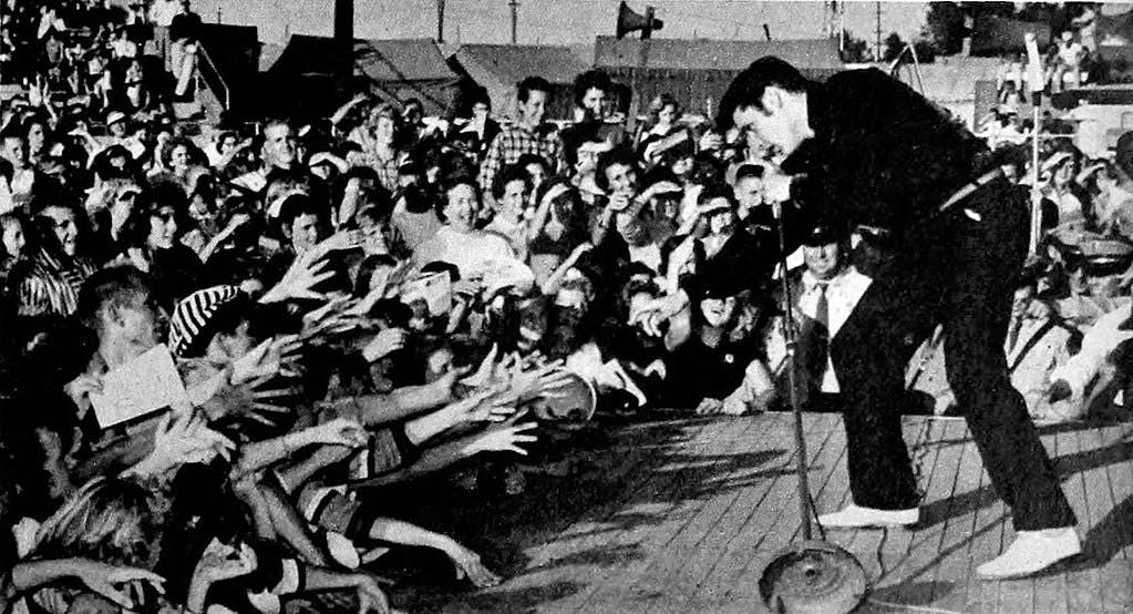 Elvis performing live at the Mississippi-Alabama Fairgrounds in Tupelo, Mississippi, September 26, 1956. (Wikimedia Commons)