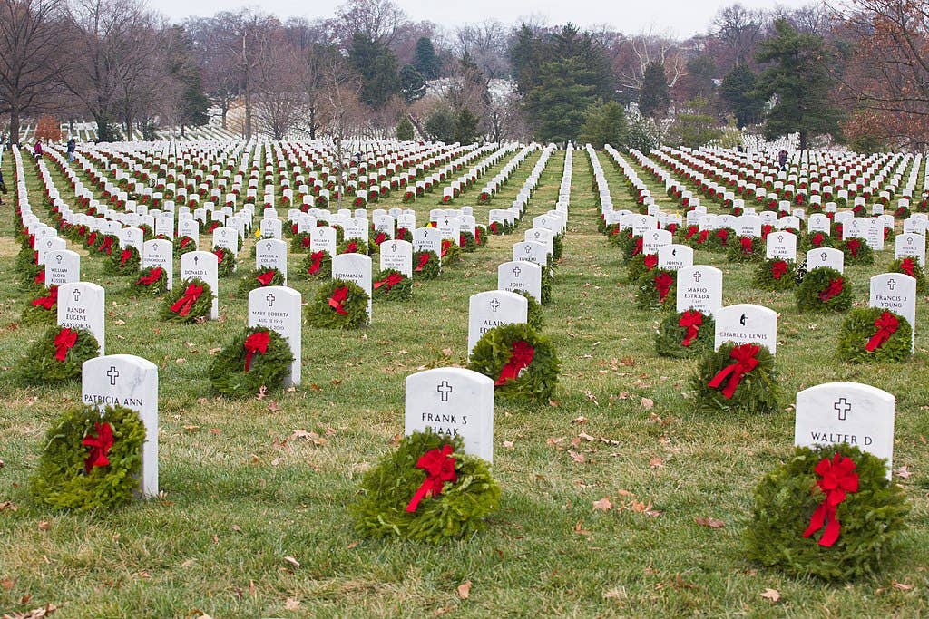 Many volunteers with Wreaths Across America help place more than 100,000 remembrance wreaths on headstones at Arlington National Cemetery, Va., Dec. 13, 2013. The mission of Wreaths Across America[1] is to remember and honor the fallen men and women of the armed forces by coordinating wreath laying ceremonies. (U.S. Army photo by Spc. James K. McCann/Released)