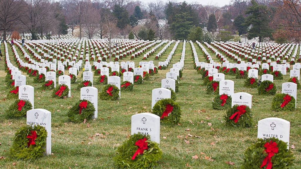 Many volunteers with Wreaths Across America help place more than 100,000 remembrance wreaths on headstones at Arlington National Cemetery, Va., Dec. 13, 2013. The mission of Wreaths Across America[1] is to remember and honor the fallen men and women of the armed forces by coordinating wreath laying ceremonies. (U.S. Army photo by Spc. James K. McCann/Released)