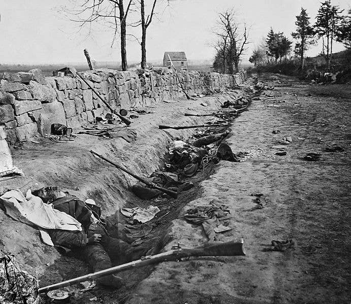 Confederate dead behind the stone wall of Marye's Heights, Virginia, killed during the Second Battle of Fredericksburg, which was in the eastern portion of the May 1863 Battle of Chancellorsville. (Wikimedia Commons)