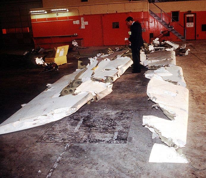 Wreckage from an Arrow Air DC-8 commercial aircraft is stored in a Gander Airport hangar for analysis by members of the Canadian Air Safety Board. (Wikimedia Commons)