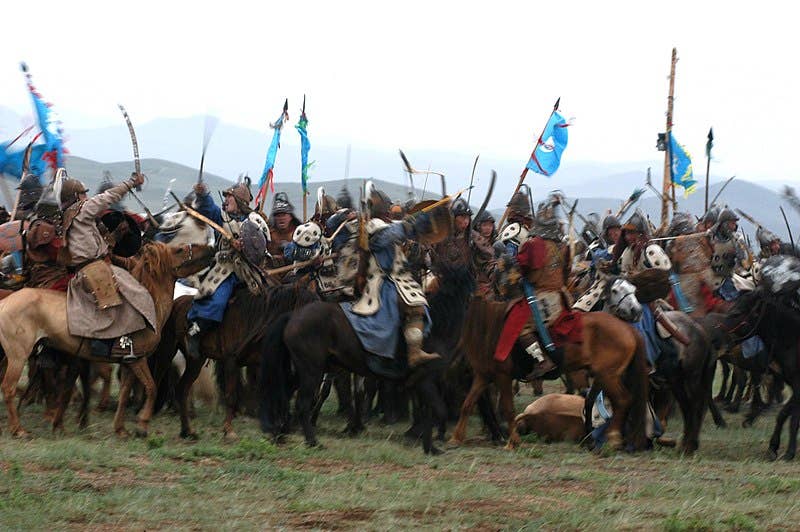 Mongolian Armed Forces clash during a mock horse-mounted battle during the opening ceremony of Khaan Quest 07 here Aug. 1. This nomadic country is hosting the multinational peacekeeping exercise for the second year in a row. (Official U. S. Marine Corps photo by Sgt. G. S. Thomas)