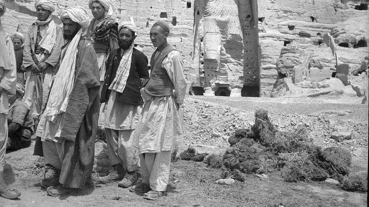 Local Afghan men standing near the larger "Salsal" Buddha statue, c. 1940. (Wikimedia Commons)