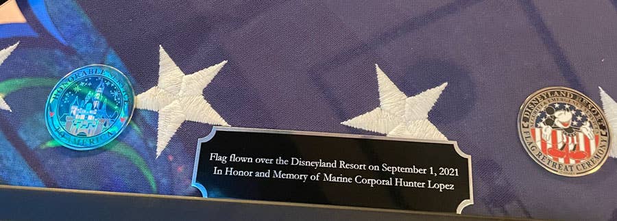 <em>The plaque of the presentation flag presented to the Lopez family by Disneyland (Disney Parks)</em>