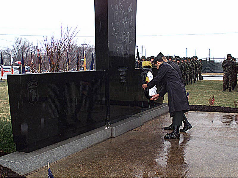 US Army Lieutenant Colonel Sidney McMannis (Obscured) and Command Sergeant Major Raymond Rodriquez (Foreground) place a wreath on the memorial for Task Force 3rd Battalion, 502nd Infantry Regiment, 2nd Brigade, 101st Airborne Division Soldiers. (Wikimedia Commons)