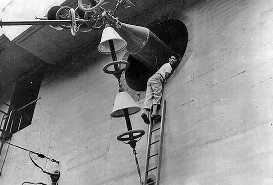<em>A Navy engineer works on an antennae at the Haʻikū Radio Station (U.S. Navy)</em>