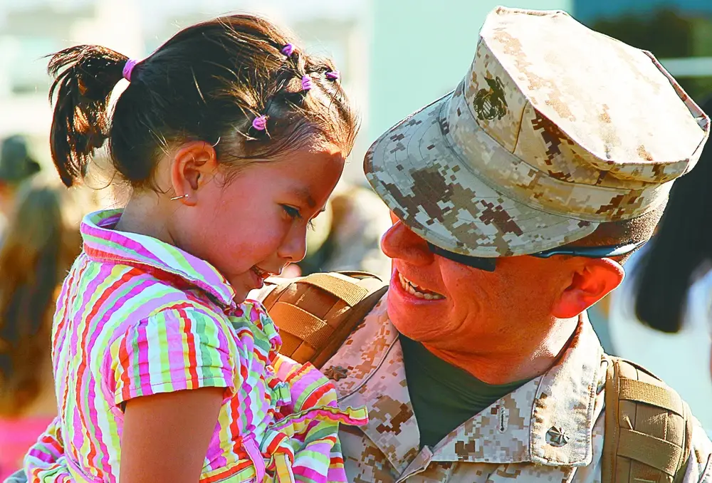 Maj. Omaar Hernandez, air officer, 7th Marines hugs his daughter, Camilla, 7, at Regimental Combat Team 7’s homecoming event at Lance Cpl. Torrey L. Gray Field, Aug. 7, 2013. (DVIDS)