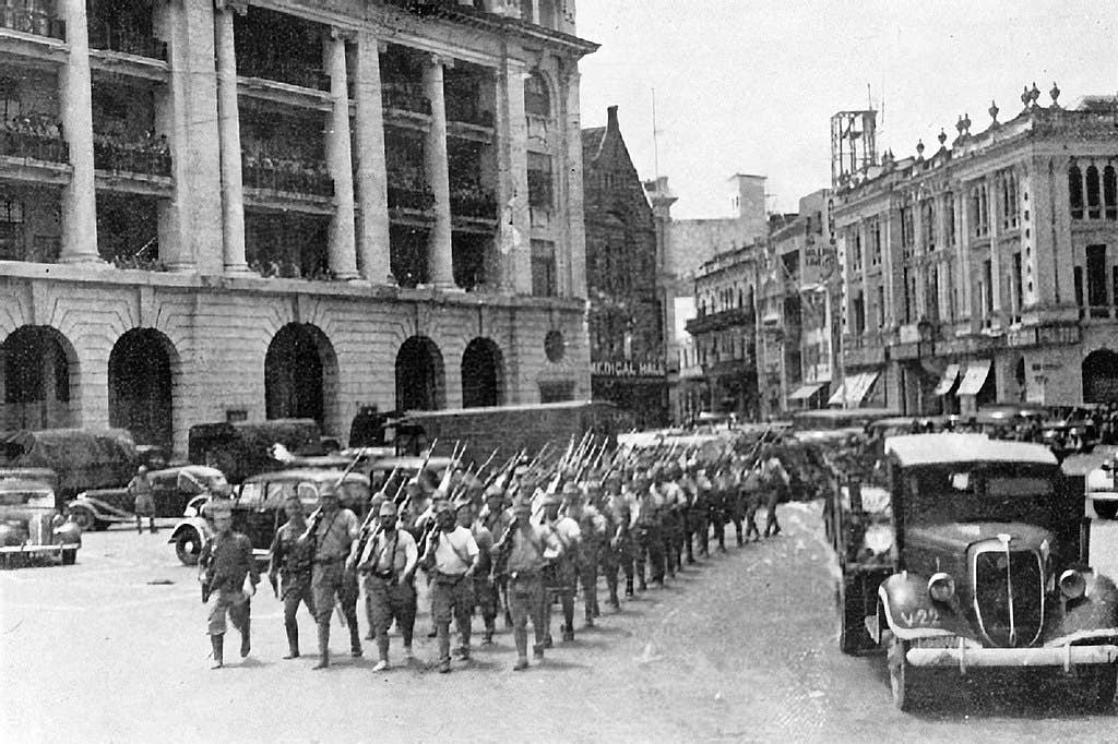 Battle of Singapore, February 1942. Japanese victorious troops march through the city centre. (Wikimedia Commons)