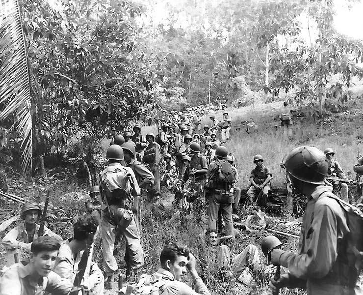 Troops from the armies 164th infantry rest at a stand still at Guadalcanal. (Wikimedia Commons)