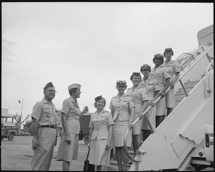 <em>The first five enlisted women in the Air Force (WAF) and the fourth WAF officer to be assigned to Vietnam arrive at Tan Son Nhut Air Base, South Vietnam. The women (left to Right) are: Lt Col June H. Hilton, A1C Carol J. Hornick, A1C Rita M. Pitcock, SSgt Barbara J. Snavely, A1C Shirley J. Brown, and A1C Eva M. Nordstrom.</em> (Wikimedia Commons)