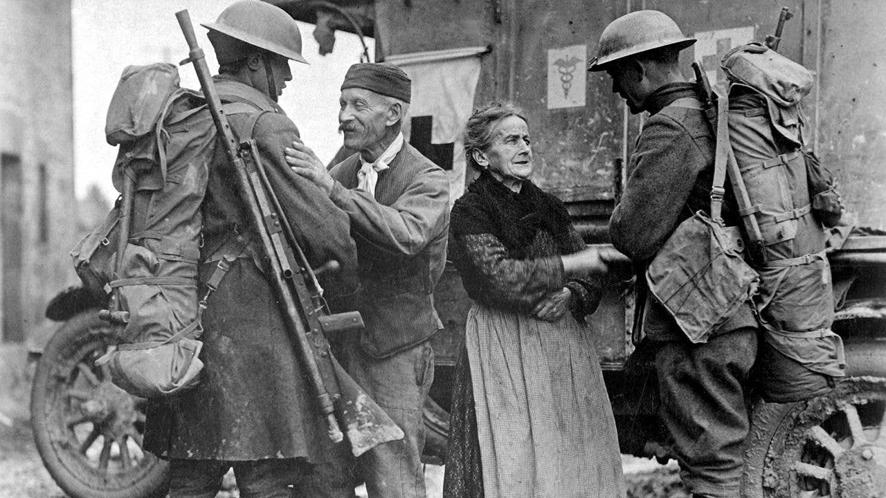 Soldiers of the American 308th and 166th Infantry Regiments liberate a French town in 1918. The soldier on the left is carrying a Chauchat slung over his shoulder. (Wikipedia)
