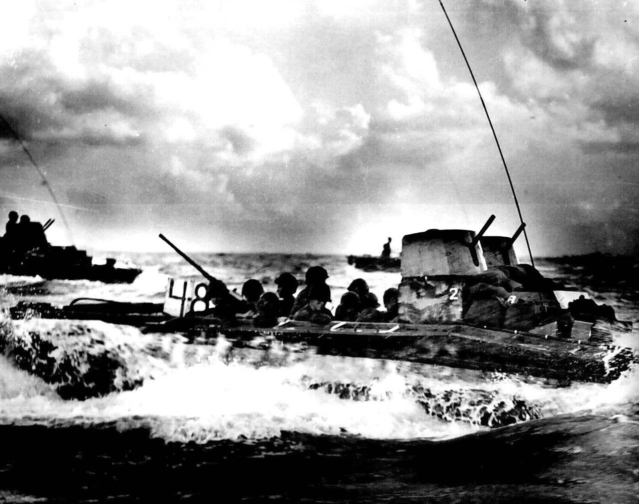 A Water Buffalo, loaded with Marines, churns through the sea bound for beaches of Tinian Island near Guam. July 1944. (National Archives photo)