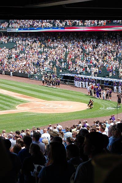 Sports fans stand for US National anthem <strong>"The Star-Spangled Banner"</strong> before a baseball game at Coors Field. (Wikipedia)