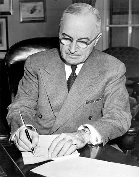 President Truman signing a proclamation declaring a national emergency and authorizing U.S. entry into the Korean War. (Wikimedia Commons)