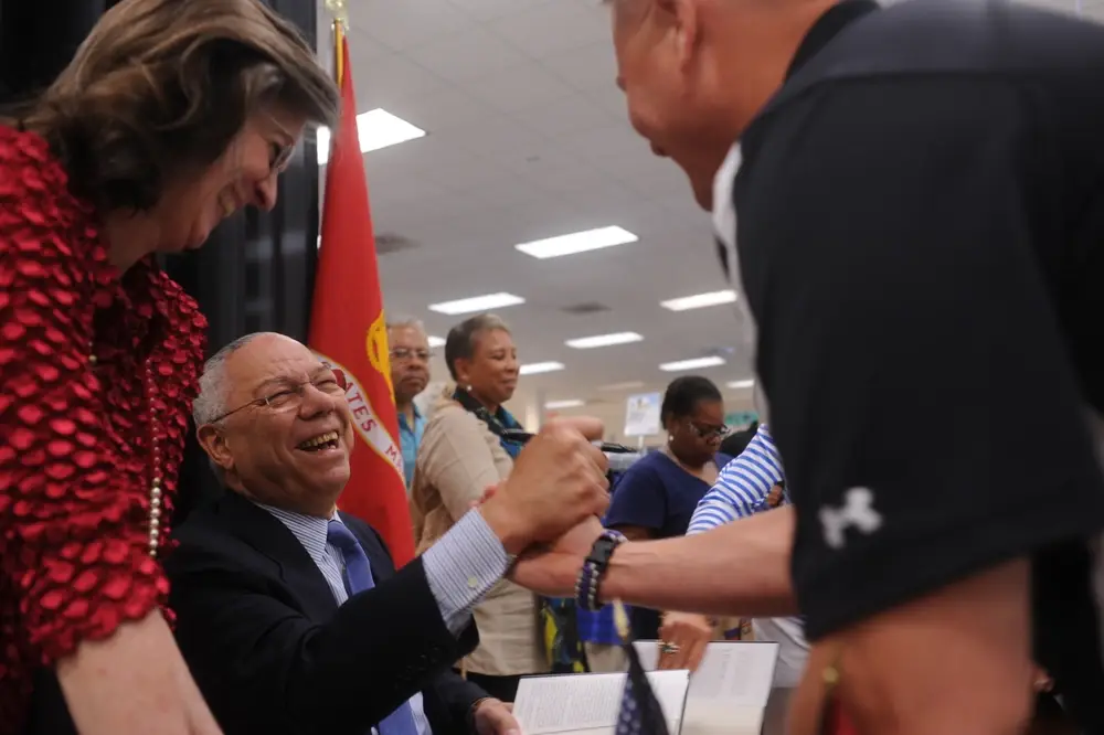<em>Colin Powell shakes hands during a book signing at Marine Corps Base Quantico (U.S. Marine Corps)</em>