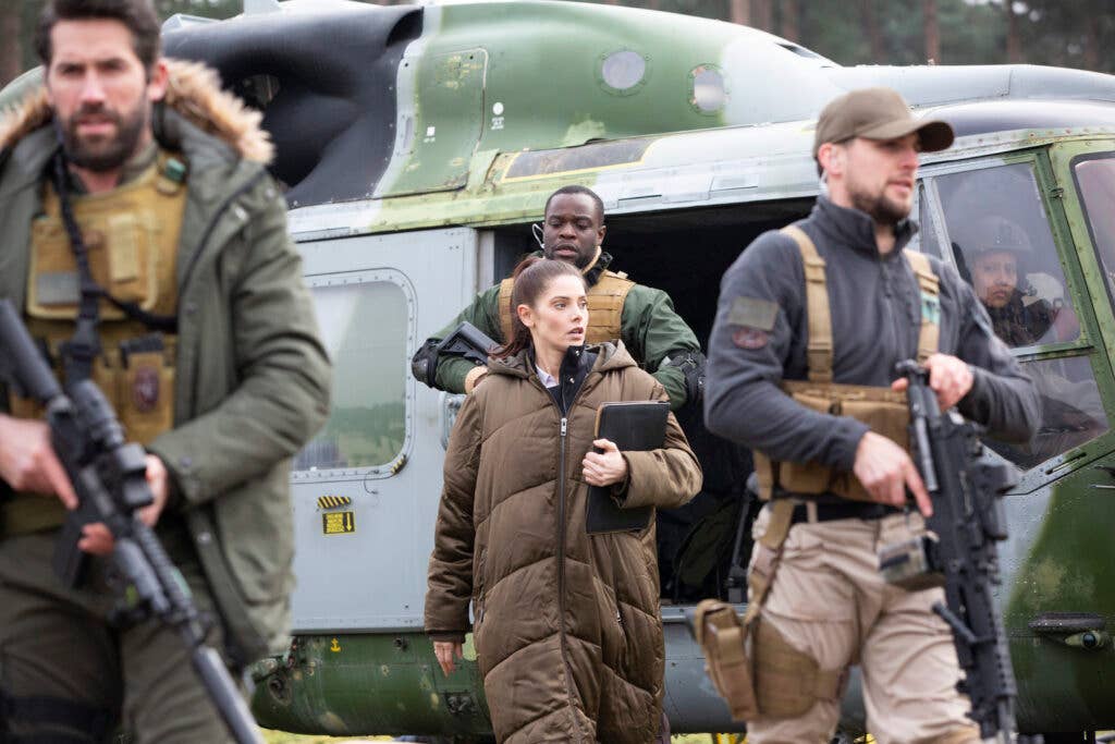 The SEAL team with &nbsp;CIA Analyst Zoe Anderson departing from the Lynx.  Photo courtesy of <em>One Shot</em>.