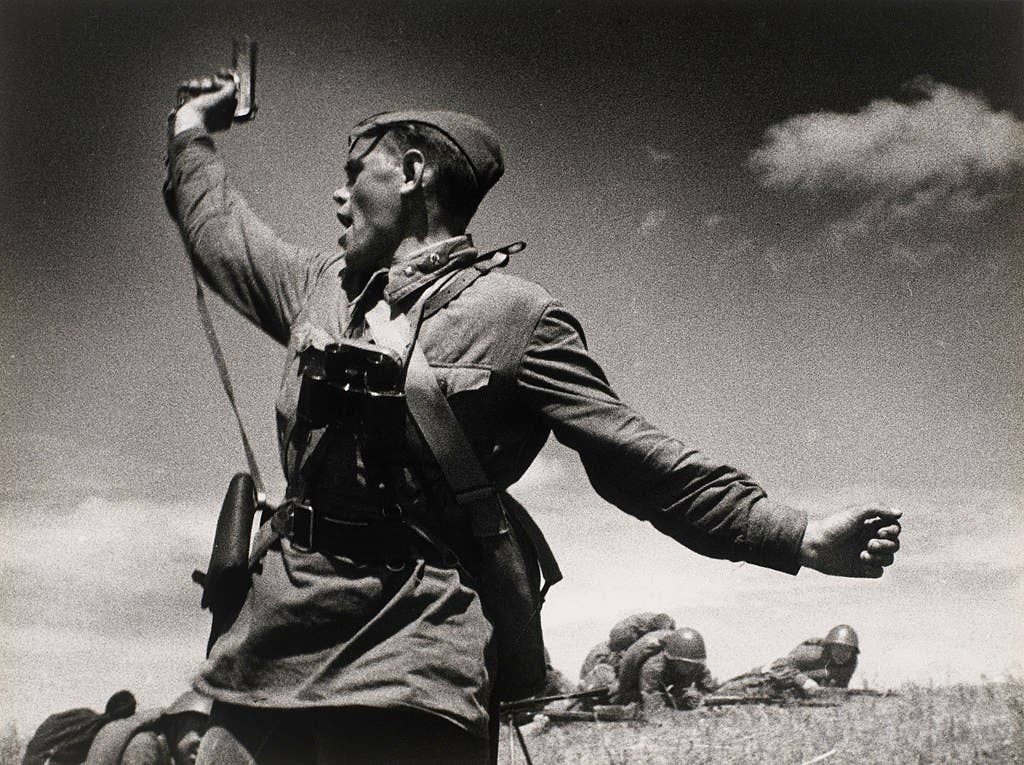 Iconic photo of a Soviet officer leading his soldiers into battle against the invading German army, 12 July 1942, in Soviet Ukraine. (Wikimedia Commons)