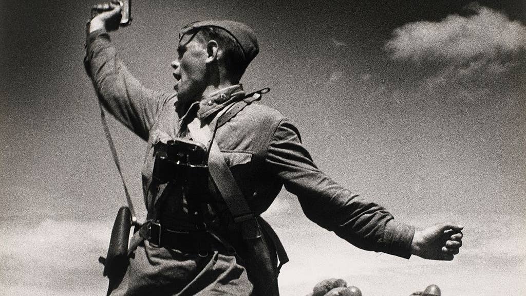 Iconic photo of a Soviet officer leading his soldiers into battle against the invading German army, 12 July 1942, in Soviet Ukraine. (Wikimedia Commons)
